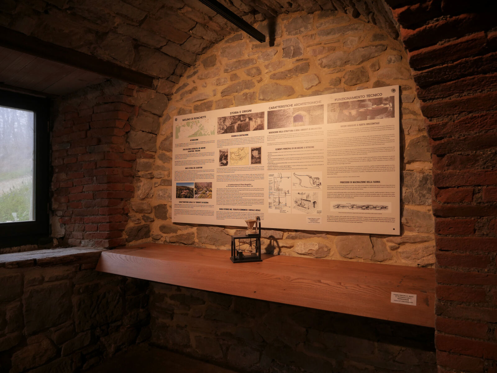 Ambiente in pietra del Molino di Ronchetti con il pannello informativo del museo